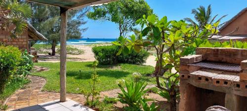 a view of the beach from a house with an umbrella at Bay View Lodge in Miramar