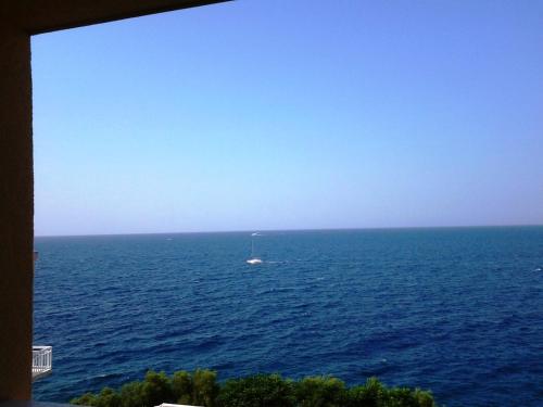 a boat in the middle of a large body of water at Apartments Punta Milna in Hvar