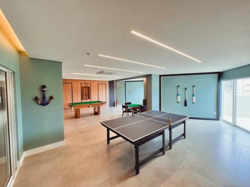 a living room with a ping pong table in it at Aquarius Residence Praia de Iracema in Fortaleza