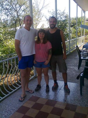 two men and a woman posing for a picture at Giorgi's Homestay in Kutaisi