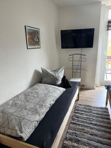 a bedroom with a bed and a flat screen tv at Ferienwohnung Zeitz Appartment Moritzburg in Zeitz