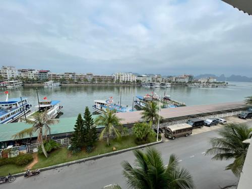 a marina with boats in a large body of water at Bảo An Hotel- Tuần Châu Hạ Long in Ha Long