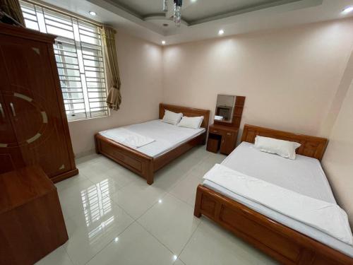 a bedroom with two beds and a window at Bảo An Hotel- Tuần Châu Hạ Long in Ha Long