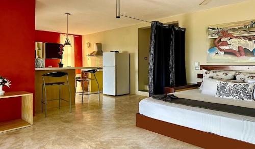 Il comprend une chambre avec un lit et une cuisine équipée d'un réfrigérateur. dans l'établissement Las Galeras Village Ecolodge, à Las Galeras