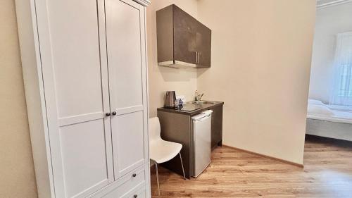 a small kitchen with a sink and a counter in a room at Kastanimaja Apartments in Tartu