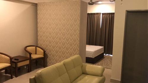 a living room with a couch and a bedroom at Hyve in Cyberjaya
