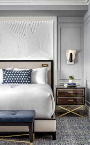 a bedroom with a white bed and a nightstand at Fairmont Royal York Hotel in Toronto
