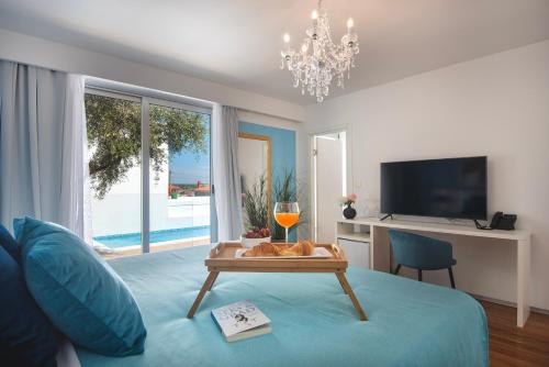 a living room with a blue couch and a table at Monvidal by Bura Hotels - Adults Only in Pula
