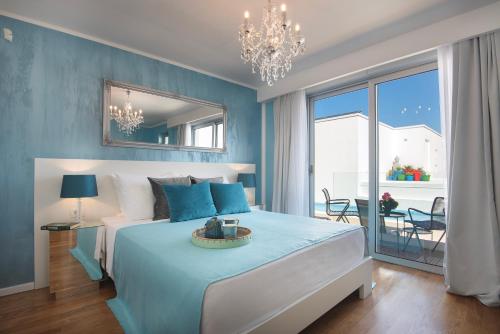 a blue bedroom with a bed and a large window at Monvidal by Bura Hotels - Adults Only in Pula