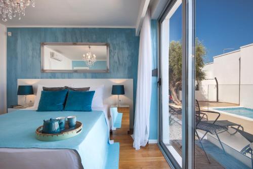 a bedroom with a king sized bed and a balcony at Monvidal by Bura Hotels - Adults Only in Pula