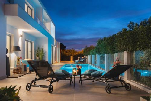 a patio with two chairs and a swimming pool at Monvidal Residence - Adults Only in Pula