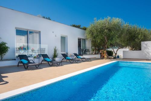 a villa with a swimming pool and a house at Monvidal by Bura Hotels - Adults Only in Pula