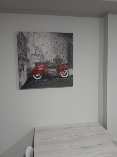 a painting of a red scooter on a wall at Apartamentos Mar y Playa in Moaña