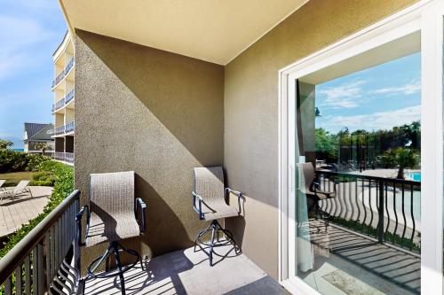 a balcony with chairs and a view of the water at Beach Resort 210 in Destin