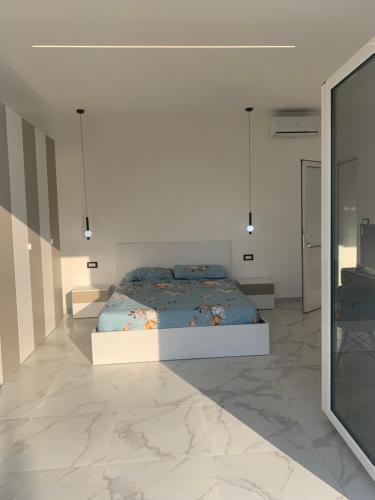 a bedroom with a bed and a large mirror at Vlora view in Vlorë