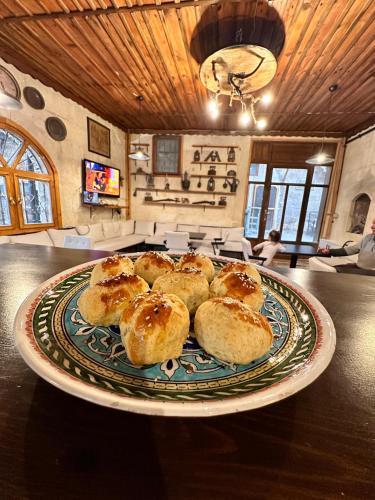 a plate of pastries sitting on a table at Tokmak Konukevi in Avanos