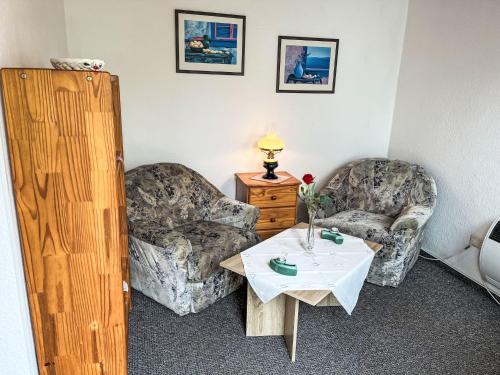 a living room with two chairs and a table at Holiday Home Weller by Interhome in Ostseebad Koserow