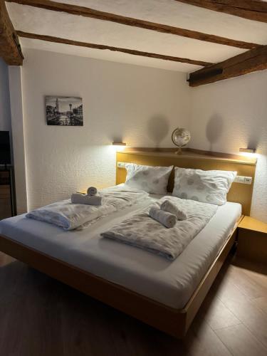 a bedroom with a bed with two towels on it at Gasthaus Hecht in Orsingen-Nenzingen