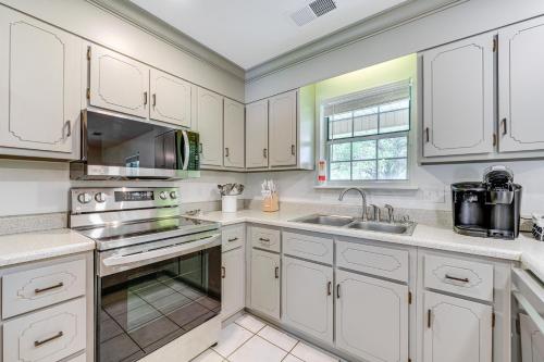 a kitchen with white cabinets and a sink at Perry Family Home on 2 Acres with Private Pool in Perry