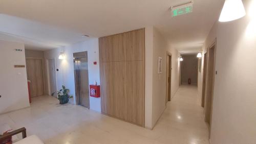 a hallway with a large wooden partition in a building at Hotel Avra in Preveza