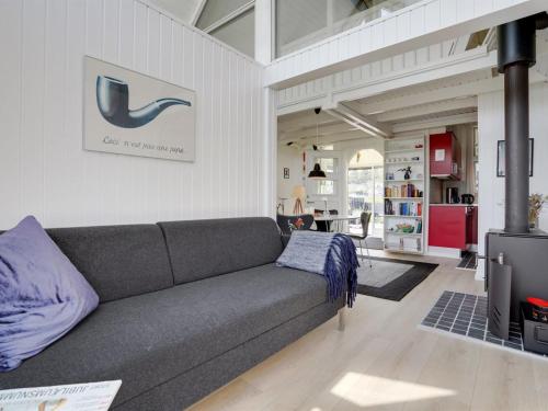 a living room with a couch and a kitchen at Holiday Home Solfrid - all inclusive - 150m from the sea by Interhome in Esbjerg