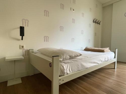 a bed in a room with a wall with drawings on it at Albergue Guiana in Ponferrada