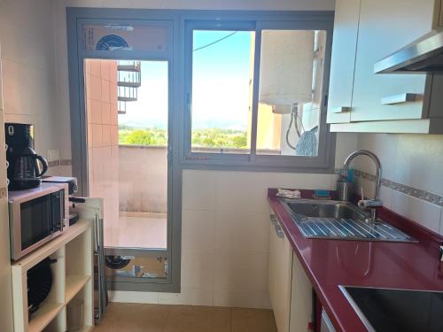 a kitchen with a sink and a window at Nature II in El Verger