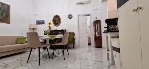 a living room with a table and chairs and a couch at La Corte dei Sarti in Copertino