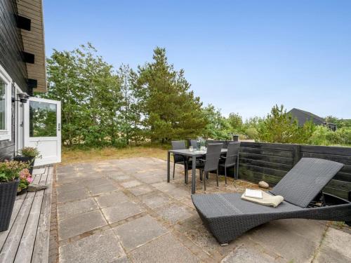 eine Terrasse mit einem Tisch und Stühlen darauf in der Unterkunft Holiday Home Oddger - all inclusive - 250m to the inlet by Interhome in Skjern