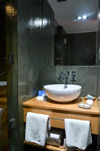 a bathroom with a sink and a mirror at Natalino Hotel Patagonia in Puerto Natales