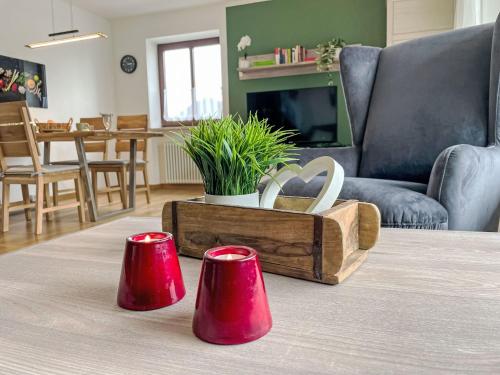 a living room with two red candles on a table at Apartment Auszeit by Interhome in Oy-Mittelberg