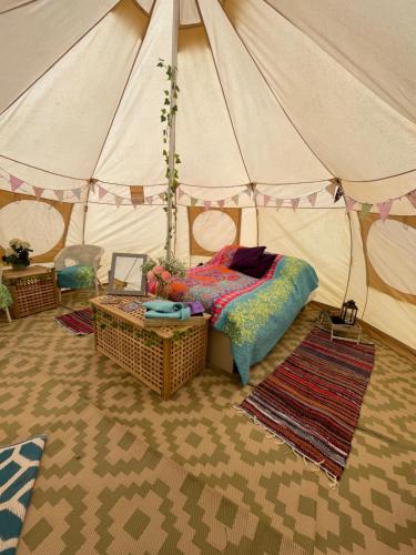 a bedroom with a bed in a tent at Nine Acres, peaceful in Brackley