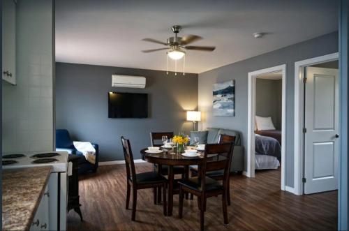 a kitchen and dining room with a table and chairs at 2 Bedroom Harbor Front Condo 10L in Roseneath