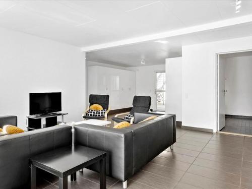 a living room with a couch and a tv at Apartment Viljo - all inclusive - 100m from the sea by Interhome in Hals