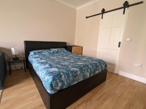 a bedroom with a bed and a white door at Cozy Getaway in Bunratty in Droíchead an Chláir