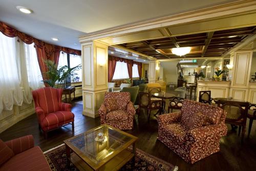 a living room with chairs and a table at Hotel De La Ville in Saint Vincent