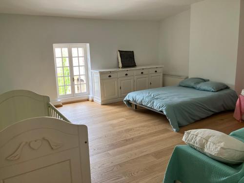 a bedroom with two beds and a dresser in it at Le mas du murier - Portes de Provence - Mas de 1890 rénové avec climatisation in Loriol-sur-Drôme