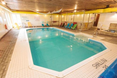 a large swimming pool in a building at Newly Renovated 2 Bedroom Beach Front Condo 2A in Lanark