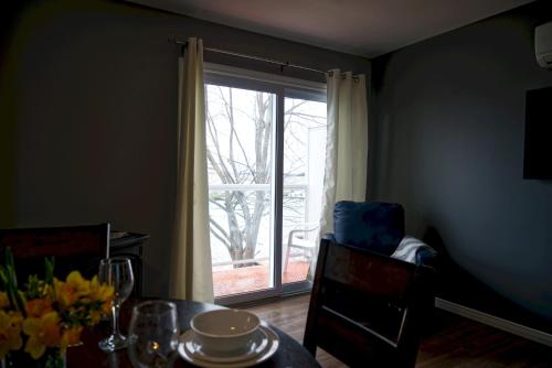 a dining room with a table and a sliding glass door at 2 Bedroom Harbor Front Condo 6L in Roseneath