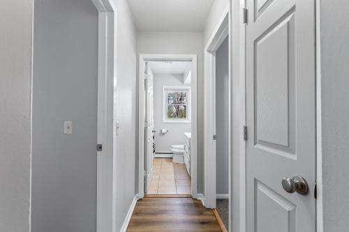 a hallway with white walls and a white door at Tranquil 2BR Apartment Mpls - 8073 Apt 2 in Minneapolis