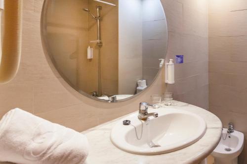 ein Bad mit einem Waschbecken und einem Spiegel in der Unterkunft Port Vista Oro in Benidorm