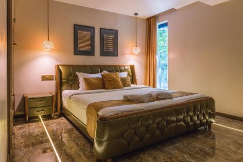 a bedroom with a large bed with a leather headboard at HIDDEN BANK: Golden in Plovdiv