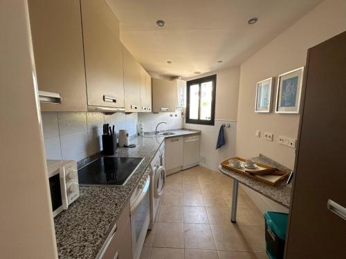 a kitchen with a sink and a counter top at Apartamento frente al mar con parking privado in Torrox
