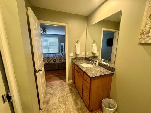 uma casa de banho com um lavatório e um espelho em Three Schooners Landing Condo 2 em Sodus Point