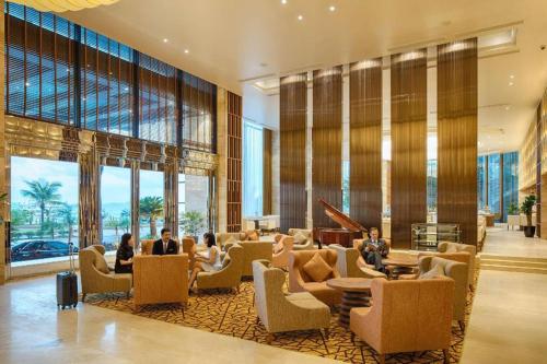 un vestíbulo con gente sentada en sillas en un edificio en Twenty eight hotel, en Hanói