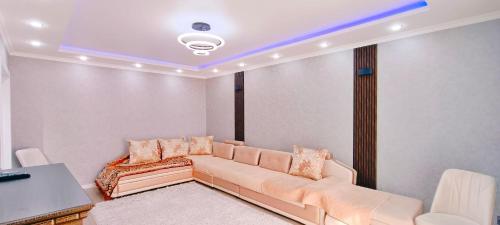 a living room with a couch and a table at Апартаменты Премиум-класса в Центре г.Семей in Semey