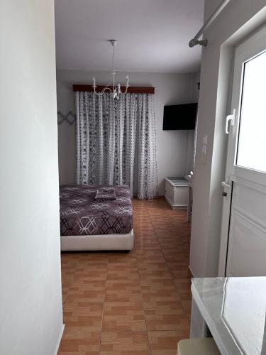 a bedroom with a bed in the middle of a room at Dionysia Studios in Kefalos
