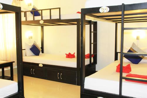 a group of bunk beds in a room at Tropical Breeze in Siem Reap