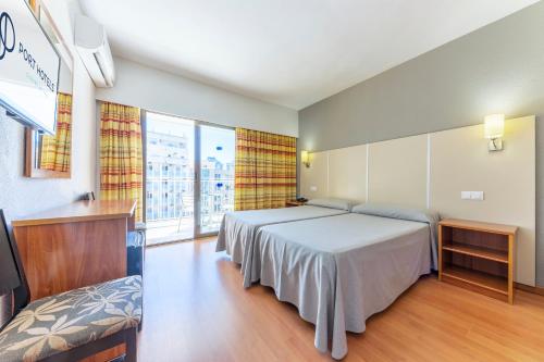 a bedroom with a bed and a large window at Port Vista Oro in Benidorm