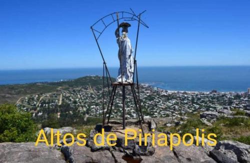 a statue on a stand on top of a mountain at Altos de Piriapolis2 in Piriápolis